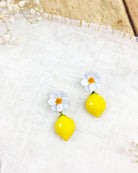 all-groups Boucles d'oreilles pendantes avec des fleurs blanches et des motifs de citron subtils.